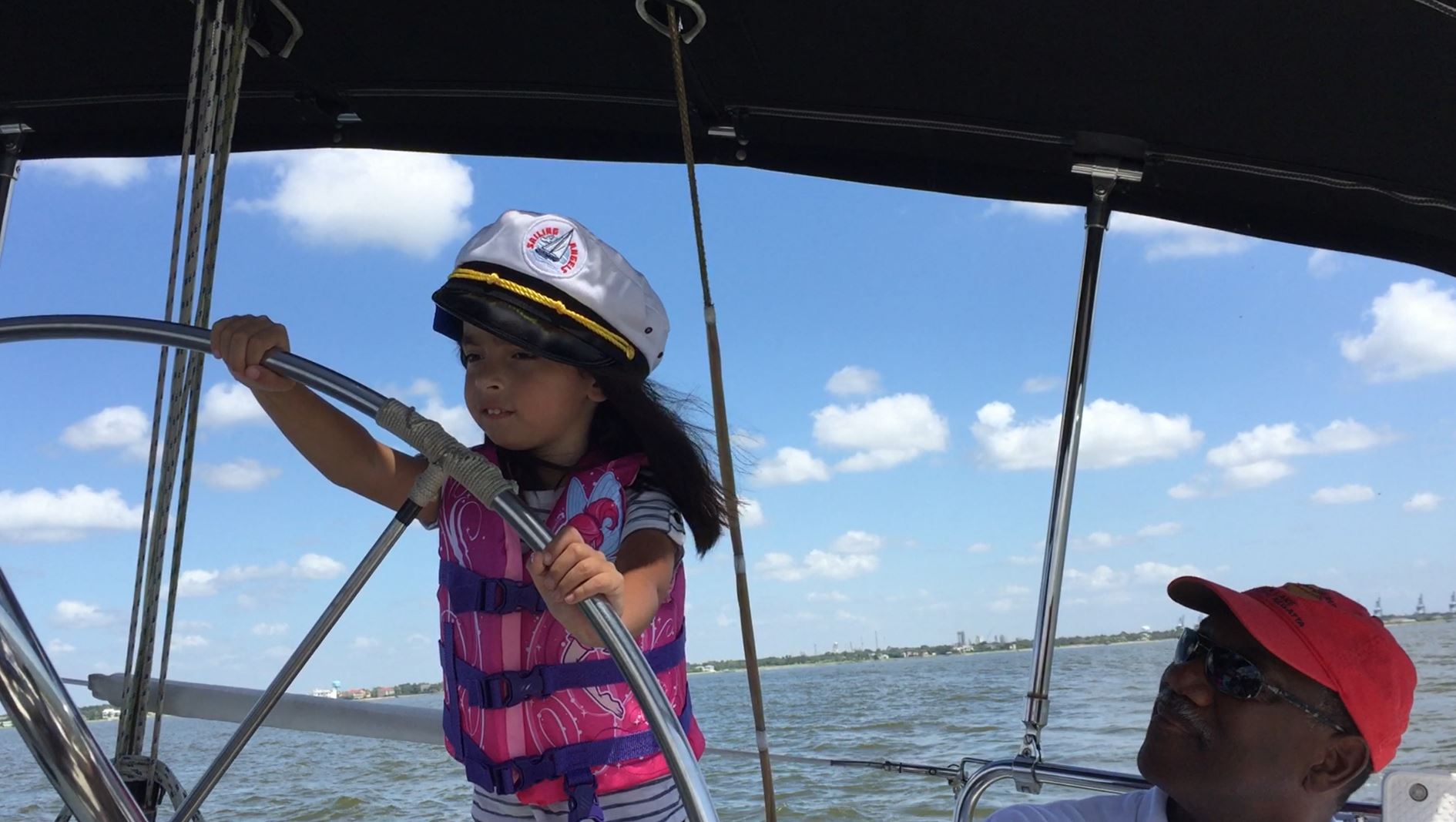 child driving boat